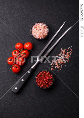 Empty meat or steak fork with vegetables, spices and other ingredients. Meat fork Empty meat or steak fork with vegetables, spices and other ingredients. Meat fork 131225775