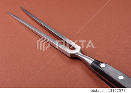 Empty meat or steak fork with vegetables, spices and other ingredients. Meat fork Empty meat or steak fork with vegetables, spices and other ingredients. Meat fork 131225784