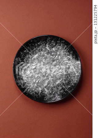 Empty round black plate for food, kitchen utensils on dining table. Empty plate Empty round black plate for food, kitchen utensils on dining table. Empty plate 131225794