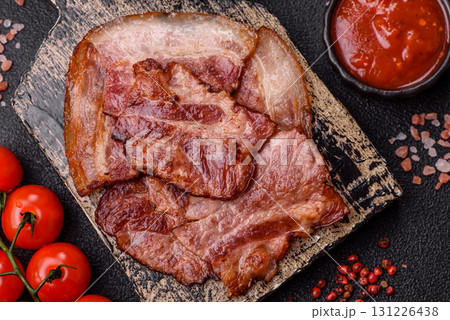 Cooked fried crispy bacon as an ingredient of a delicious English breakfast. Pieces of fried bacon Cooked fried crispy bacon as an ingredient of a delicious English breakfast. Pieces of fried bacon 131226438