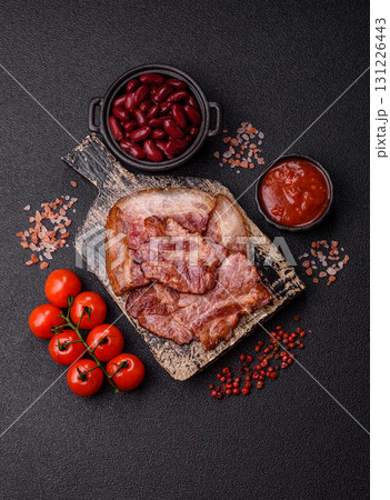 Cooked fried crispy bacon as an ingredient of a delicious English breakfast. Pieces of fried bacon Cooked fried crispy bacon as an ingredient of a delicious English breakfast. Pieces of fried bacon 131226443