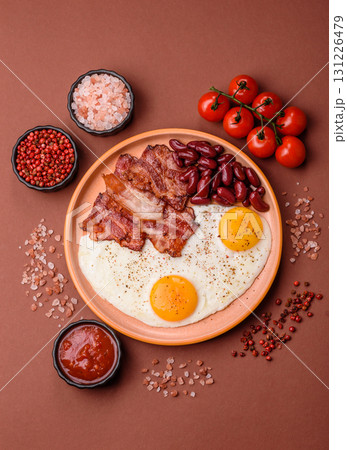 Fried egg, bacon and beans, a classic British breakfast with tomatoes. Egg, bacon and beans 131226479