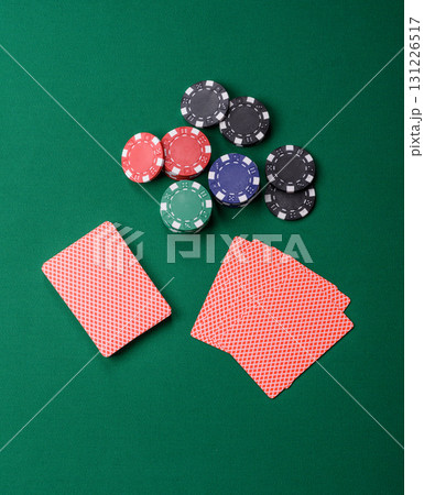 Playing card game poker in casino with chips, bets and risk. Cards and chips on elt Playing card game poker in casino with chips, bets and risk. Cards and chips on elt 131226517