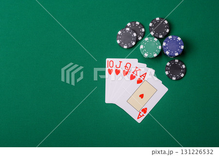 Playing card game poker in casino with chips, bets and risk. Cards and chips on elt Playing card game poker in casino with chips, bets and risk. Cards and chips on elt 131226532