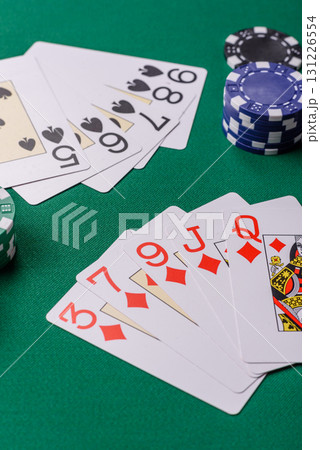 Playing card game poker in casino with chips, bets and risk. Cards and chips on elt 131226554