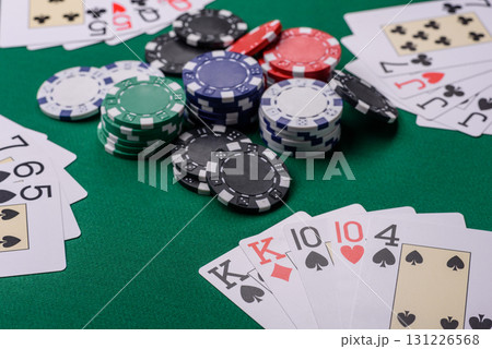 Playing card game poker in casino with chips, bets and risk. Cards and chips on elt Playing card game poker in casino with chips, bets and risk. Cards and chips on elt 131226568