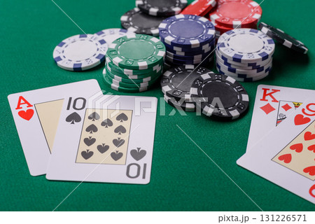 Playing blackjack or baccarat card game in casino with chips, bets and risk. Cards and chips on felt 131226571