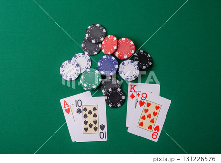 Playing blackjack or baccarat card game in casino with chips, bets and risk. Cards and chips on felt 131226576