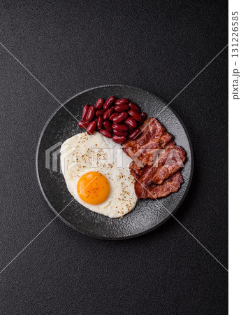 Fried egg, bacon and beans, a classic British breakfast with tomatoes. Egg, bacon and beans 131226585