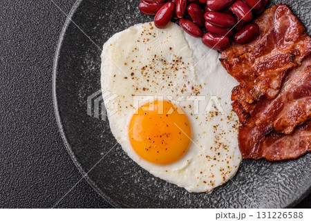 Fried egg, bacon and beans, a classic British breakfast with tomatoes. Egg, bacon and beans 131226588