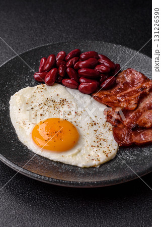 Fried egg, bacon and beans, a classic British breakfast with tomatoes. Egg, bacon and beans 131226590