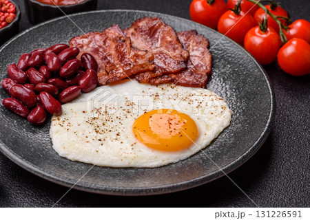 Fried egg, bacon and beans, a classic British breakfast with tomatoes. Egg, bacon and beans 131226591