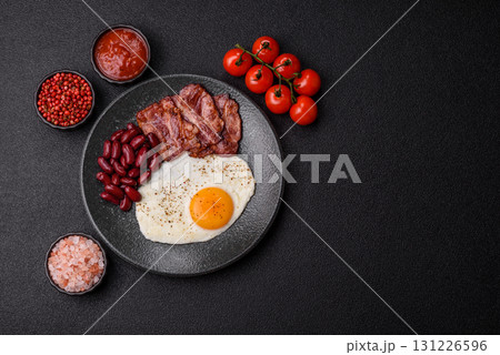 Fried egg, bacon and beans, a classic British breakfast with tomatoes. Egg, bacon and beans 131226596