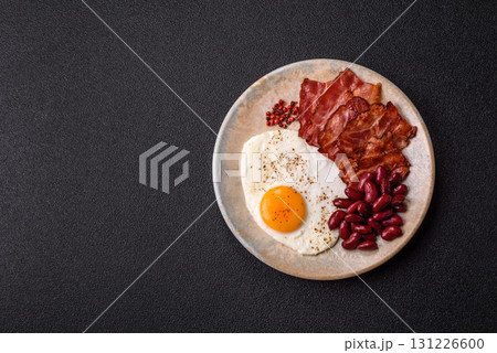 Fried egg, bacon and beans, a classic British breakfast with tomatoes. Egg, bacon and beans 131226600