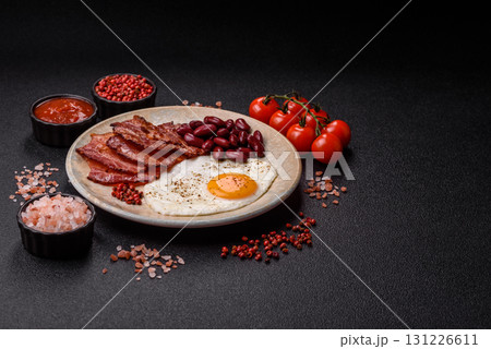 Fried egg, bacon and beans, a classic British breakfast with tomatoes. Egg, bacon and beans 131226611
