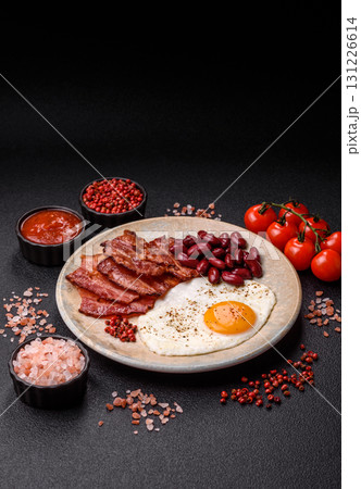 Fried egg, bacon and beans, a classic British breakfast with tomatoes. Egg, bacon and beans 131226614