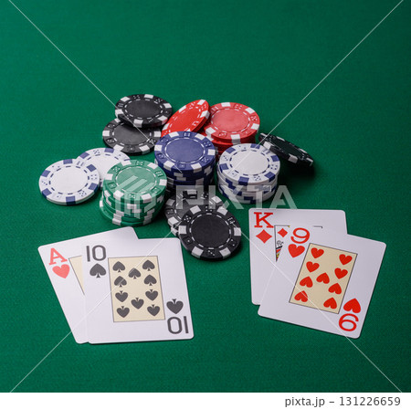 Playing blackjack or baccarat card game in casino with chips, bets and risk. Cards and chips on felt 131226659