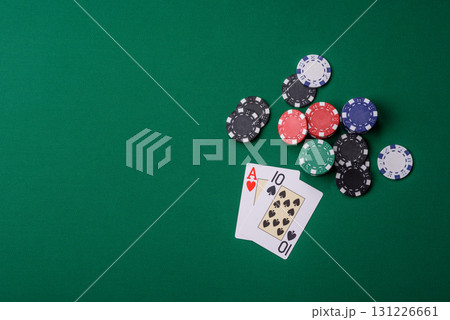 Playing blackjack or baccarat card game in casino with chips, bets and risk. Cards and chips on felt 131226661