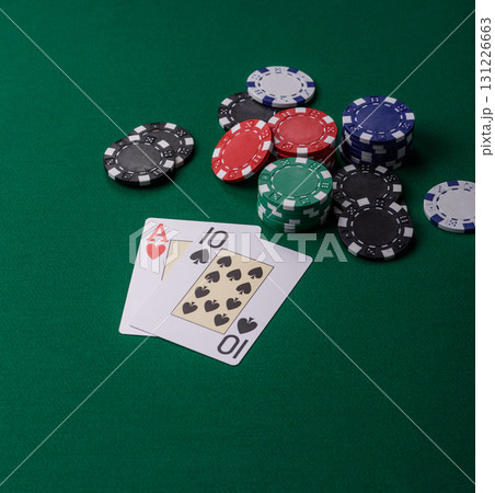 Playing blackjack or baccarat card game in casino with chips, bets and risk. Cards and chips on felt 131226663