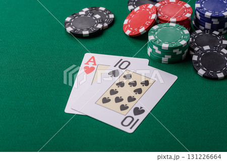 Playing blackjack or baccarat card game in casino with chips, bets and risk. Cards and chips on felt Playing blackjack or baccarat card game in casino with chips, bets and risk. Cards and chips on felt 131226664
