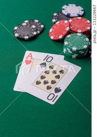 Playing blackjack or baccarat card game in casino with chips, bets and risk. Cards and chips on felt Playing blackjack or baccarat card game in casino with chips, bets and risk. Cards and chips on felt 131226667