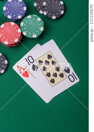 Playing blackjack or baccarat card game in casino with chips, bets and risk. Cards and chips on felt Playing blackjack or baccarat card game in casino with chips, bets and risk. Cards and chips on felt 131226670