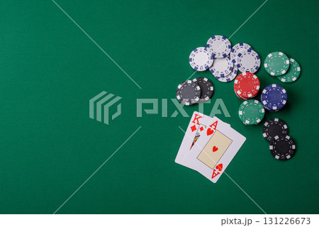 Playing blackjack or baccarat card game in casino with chips, bets and risk. Cards and chips on felt Playing blackjack or baccarat card game in casino with chips, bets and risk. Cards and chips on felt 131226673