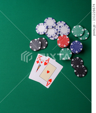 Playing blackjack or baccarat card game in casino with chips, bets and risk. Cards and chips on felt 131226674