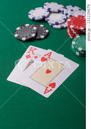 Playing blackjack or baccarat card game in casino with chips, bets and risk. Cards and chips on felt 131226679