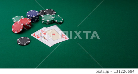 Playing blackjack or baccarat card game in casino with chips, bets and risk. Cards and chips on felt 131226684