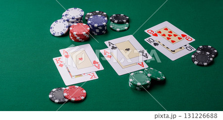 Playing blackjack or baccarat card game in casino with chips, bets and risk. Cards and chips on felt 131226688