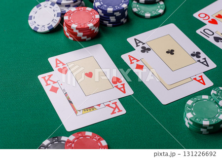 Playing blackjack or baccarat card game in casino with chips, bets and risk. Cards and chips on felt Playing blackjack or baccarat card game in casino with chips, bets and risk. Cards and chips on felt 131226692