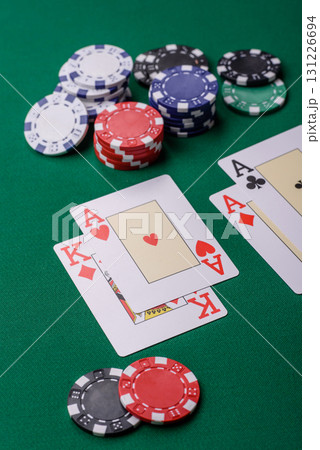 Playing blackjack or baccarat card game in casino with chips, bets and risk. Cards and chips on felt 131226694