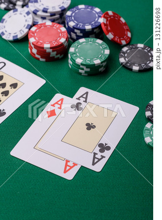 Playing blackjack or baccarat card game in casino with chips, bets and risk. Cards and chips on felt 131226698