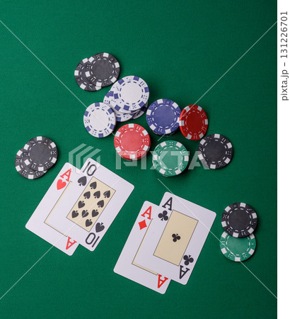 Playing blackjack or baccarat card game in casino with chips, bets and risk. Cards and chips on felt Playing blackjack or baccarat card game in casino with chips, bets and risk. Cards and chips on felt 131226701