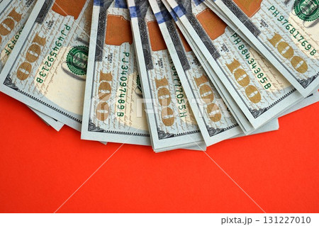 Big amount of United States hundred dollar bills on red background 131227010