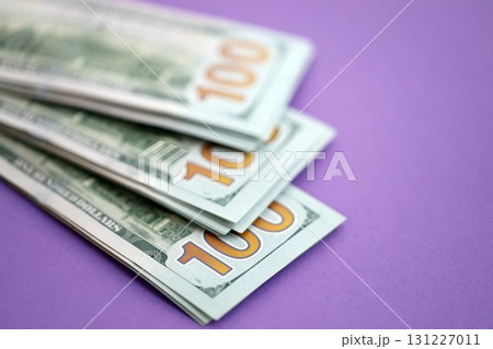 Big amount of United States hundred dollar bills on purple background 131227011