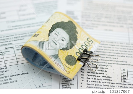 South Korean won money bills in big amount lies on table with tax forms close up 131227067
