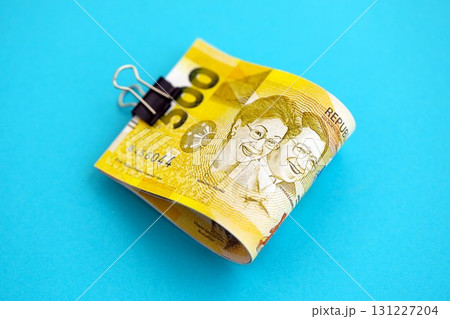 Philippines peso money bills in big amount on blue. Finance and banking concept 131227204