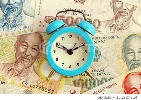 Vietnamese dong currency money bills and alarm clock. The concept of time management and income Vietnamese dong currency money bills and alarm clock. The concept of time management and income 131227214
