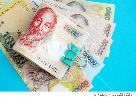 Vietnamese dong money bills in big amount on blue. Finance and banking concept Vietnamese dong money bills in big amount on blue. Finance and banking concept 131227228