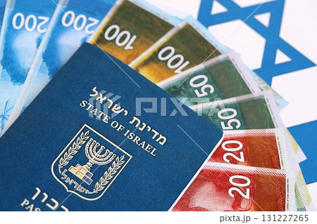 Israel New Shekels banknotes and passport on flag. The current Israel money bills and pass Israel New Shekels banknotes and passport on flag. The current Israel money bills and pass 131227265