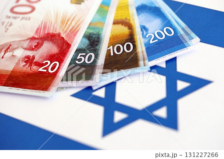 Israel New Shekels banknotes on national flag. The current Israel money bills lies on flag Israel New Shekels banknotes on national flag. The current Israel money bills lies on flag 131227266