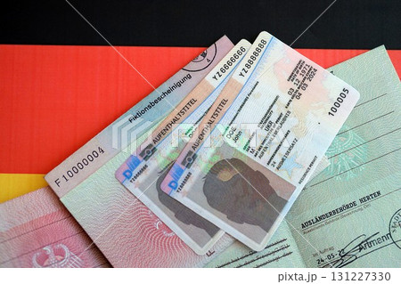 German Permanent resident card and temporary document lies on Germany flag 131227330
