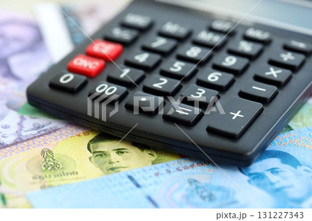 Thai baht currency money bills and calculator. The concept of taxation and money count Thai baht currency money bills and calculator. The concept of taxation and money count 131227343