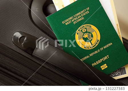 Nigerian passport and avia tickets on travel bag. The concept of travel and vacation Nigerian passport and avia tickets on travel bag. The concept of travel and vacation 131227383