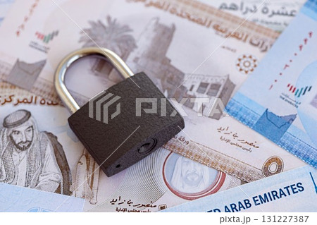 United Arab Emirates dirham currency money bills and padlock. The concept of sanctions and financial safety United Arab Emirates dirham currency money bills and padlock. The concept of sanctions and financial safety 131227387