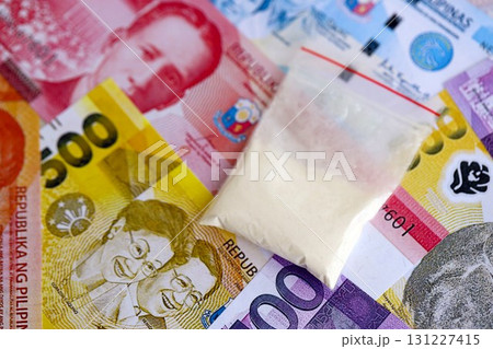 Philippines peso currency money bills and cocaine pack. The concept of drug trafficking 131227415
