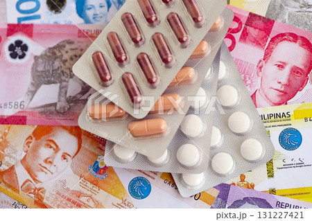 Philippines peso currency money bills and medicine pills. The concept of medicine and pharmacy Philippines peso currency money bills and medicine pills. The concept of medicine and pharmacy 131227421