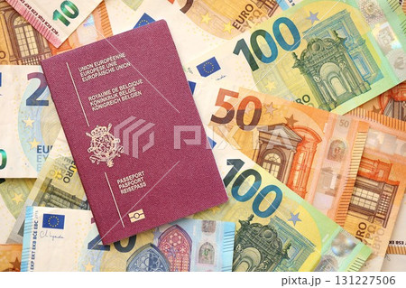 Belgium passport lies on big amount of euro money banknotes. Rich life and travel in Europe Belgium passport lies on big amount of euro money banknotes. Rich life and travel in Europe 131227506
